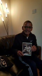 Neville Shenbanjo holding a photo of his father Akin and himself as a young child. Neville Shenbanjo Collection. 