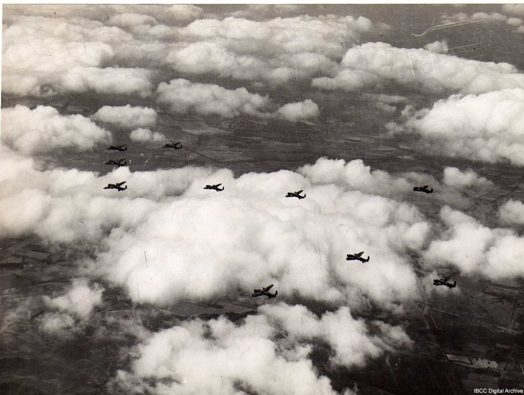 Air-to-air photograph of ten Lancasters against backdrop of cloud and terrain, submitted with caption; “514 sqdn on way to Regensburg 20/4/45”